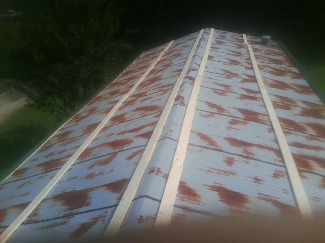 Rusted metal roof panels with new wood purlins before replacement — Storm Damage Roof Repair in Arverne by Roofing Brothers